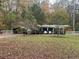 Single story home with carport and fenced yard at 3780 Hutcheson Ferry Rd, Whitesburg, GA 30185