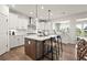 Modern kitchen featuring a large island and breakfast bar, stainless steel appliances, and white cabinetry at 5505 Julep Ct, Cumming, GA 30028