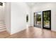 Bright hallway with light hardwood floors and access to a patio at 192 East Lake Se Ter, Atlanta, GA 30317