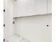 Bright laundry room featuring white cabinets and hexagon tile floor at 192 East Lake Se Ter, Atlanta, GA 30317