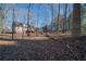 House nestled in a wooded area with a large yard at 633 Duncan Rd, Oxford, GA 30054