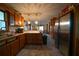 Open kitchen with stainless steel appliances and wood cabinets at 633 Duncan Rd, Oxford, GA 30054