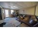 Living area featuring a brown sectional and access door at 633 Duncan Rd, Oxford, GA 30054
