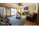 Bright living room with hardwood floors, comfy furniture, and large windows at 633 Duncan Rd, Oxford, GA 30054