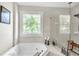 Bathroom with soaking tub, walk-in shower, and stained glass window at 1037 Emory Parc Pl, Decatur, GA 30033
