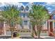Brick front elevation of charming townhome with attached garage and landscaping at 1037 Emory Parc Pl, Decatur, GA 30033