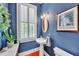 Powder room with pedestal sink, window with shutters, and tasteful wall art at 1037 Emory Parc Pl, Decatur, GA 30033