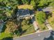 Aerial view of the home nestled among mature trees, with a pool nearby, offering a serene and private setting at 1354 Drayton Woods Dr, Tucker, GA 30084