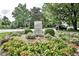 Entrance sign for Ansley Park with red flowers at 217 Westminster Dr, Atlanta, GA 30309