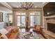 Basement living area with fireplace, hardwood floors, and access to patio at 922 Little Darby Ln, Suwanee, GA 30024