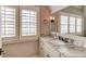 Elegant bathroom with granite countertop, updated fixtures, and plantation shutters at 922 Little Darby Ln, Suwanee, GA 30024