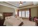 Bedroom with a large bed and plantation shutters at 922 Little Darby Ln, Suwanee, GA 30024