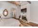 Bright bedroom with fireplace, hardwood floors, and access to the bathroom at 922 Little Darby Ln, Suwanee, GA 30024