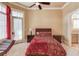 Bedroom with hardwood floors, red bedding, and a sitting area at 922 Little Darby Ln, Suwanee, GA 30024