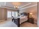 Spacious bedroom with a large bed and plantation shutters at 922 Little Darby Ln, Suwanee, GA 30024