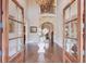 Grand entry with hardwood floors & a glass-top table at 922 Little Darby Ln, Suwanee, GA 30024