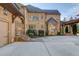 Elegant home exterior with stone accents and attached garage at 922 Little Darby Ln, Suwanee, GA 30024