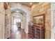 Elegant hallway with stone archways and hardwood floors at 922 Little Darby Ln, Suwanee, GA 30024