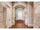 Elegant hallway with stone archways and hardwood floors at 922 Little Darby Ln, Suwanee, GA 30024