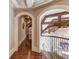Elegant hallway with arched doorways and hardwood floors at 922 Little Darby Ln, Suwanee, GA 30024