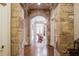 Stone hallway with hardwood floors and access to a living area at 922 Little Darby Ln, Suwanee, GA 30024