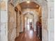 Elegant hallway with stone archways and hardwood floors at 922 Little Darby Ln, Suwanee, GA 30024