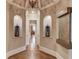Stunning foyer with hardwood floors, arched niches, and a water feature at 922 Little Darby Ln, Suwanee, GA 30024