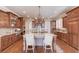 Elegant kitchen with granite island, double ovens, and rich wood cabinetry at 922 Little Darby Ln, Suwanee, GA 30024