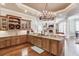 Island kitchen with granite countertops, custom cabinetry, and breakfast bar at 922 Little Darby Ln, Suwanee, GA 30024