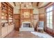 Wood paneled library with built-in shelves & fireplace at 922 Little Darby Ln, Suwanee, GA 30024