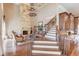 Two-story living room with stone fireplace and a grand chandelier at 922 Little Darby Ln, Suwanee, GA 30024