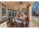 Covered patio with dining table and wooded views at 922 Little Darby Ln, Suwanee, GA 30024