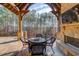 Covered patio with fireplace, seating area, and wooded views at 922 Little Darby Ln, Suwanee, GA 30024
