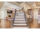 Grand staircase with iron railings and hardwood treads at 922 Little Darby Ln, Suwanee, GA 30024