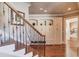 Elegant staircase with wrought iron railing and built-in storage at 922 Little Darby Ln, Suwanee, GA 30024