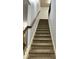 Staircase with carpeted steps and a wooden handrail at 2249 Knoxhill Se Vw, Smyrna, GA 30082