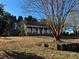 House with a large tree in front and a sloped yard at 3709 Charlotte Dr, Rex, GA 30273