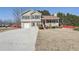 Two-story house with gray siding, a porch, and a driveway at 4354 Fiddlers Bend, Loganville, GA 30052