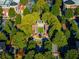 Aerial view of a community with lush green spaces and a central plaza at 4910 Crestline View Rd, Cumming, GA 30028