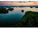 Scenic sunset view over a tranquil lake with islands at 4910 Crestline View Rd, Cumming, GA 30028