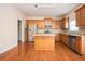 Eat-in kitchen with island, stainless steel appliances, and hardwood floors at 558 Olympic Way, Acworth, GA 30102