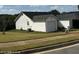 Rear view of house showcasing garage and yard at 416 Autumn Lake Ct, Mcdonough, GA 30253