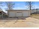 Three-car garage with white doors and concrete driveway at 207 Arcado Nw Rd, Lilburn, GA 30047