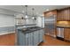 Updated kitchen features stainless steel appliances and an island with a cooktop at 207 Arcado Nw Rd, Lilburn, GA 30047