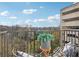 Condo balcony with chairs overlooking a tree filled vista at 2277 Peachtree Ne Rd # 405, Atlanta, GA 30309