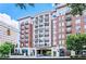 Elegant condominium building featuring brick facade, multiple balconies, and street-level retail at 2277 Peachtree Ne Rd # 405, Atlanta, GA 30309