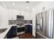 This modern kitchen features stainless steel appliances, white countertops, two tone cabinets and wood floors at 2277 Peachtree Ne Rd # 405, Atlanta, GA 30309