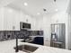 Bright well lit kitchen features stainless steel appliances, white countertops and a modern decorative backsplash at 2277 Peachtree Ne Rd # 405, Atlanta, GA 30309
