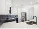 Modern kitchen features stainless steel appliances, white countertops and two tone cabinets with modern hardware at 2277 Peachtree Ne Rd # 405, Atlanta, GA 30309