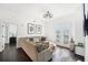 Bright living room features a gray sectional sofa and glass doors offering plenty of sunlight at 2277 Peachtree Ne Rd # 405, Atlanta, GA 30309